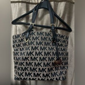 Michael Kors beige handbag, black MK lettering and gold-tone exterior hardware
